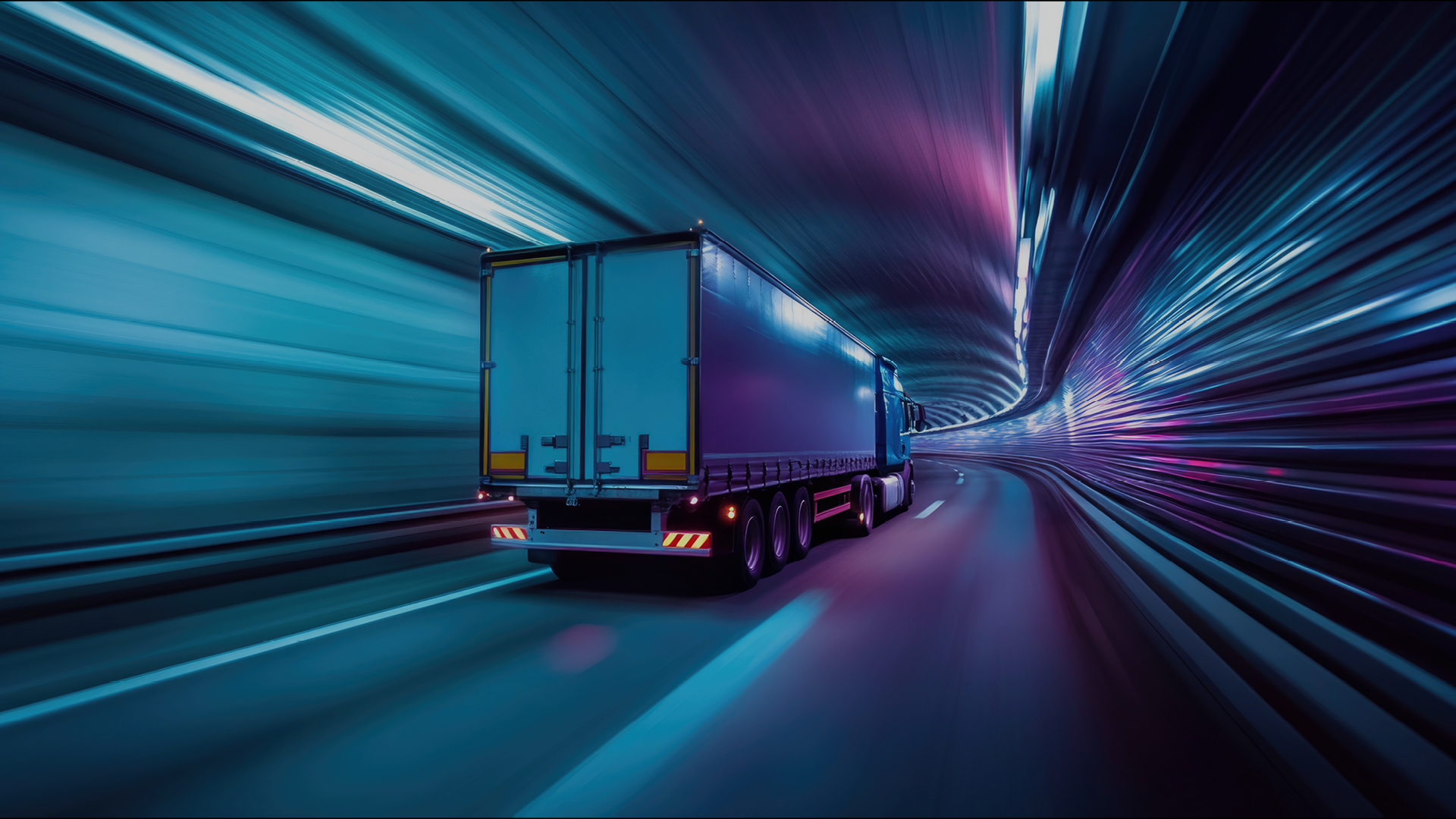 LKW fährt schnell durch futuristisch beleuchteten Tunnel.
