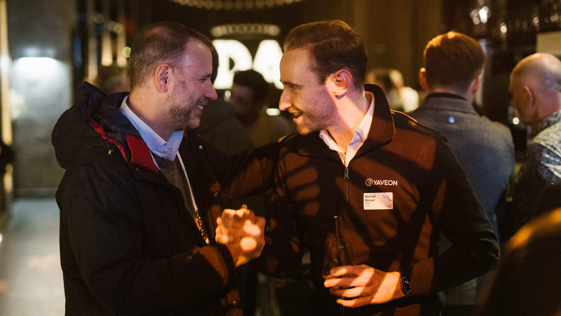 Two men in conversation at a networking event.