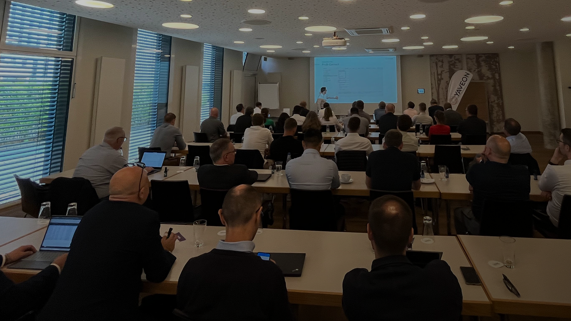 Business presentation with attendees in a conference room.