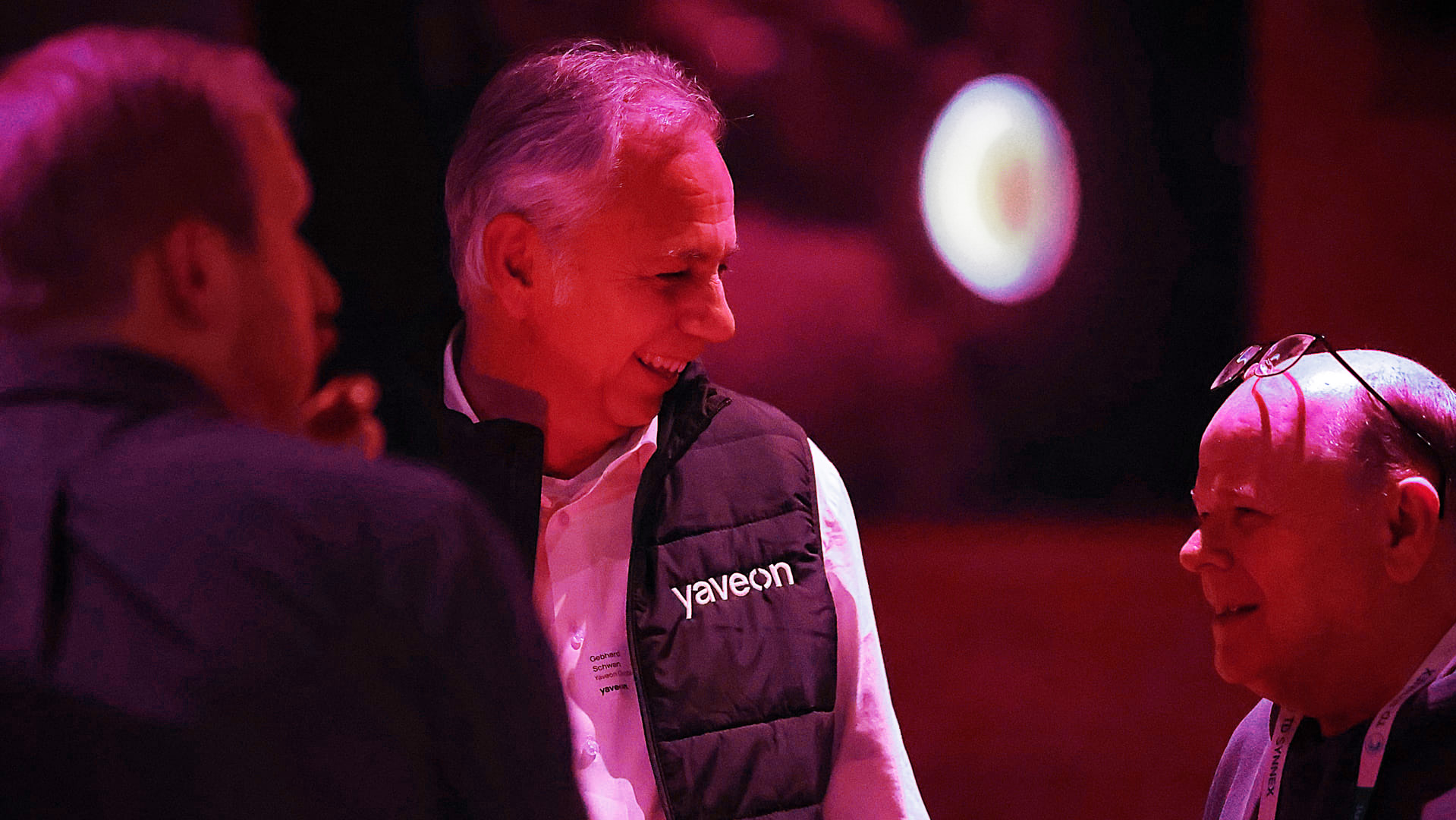 Drei Männer unterhalten sich in stimmungsvoller Beleuchtung.