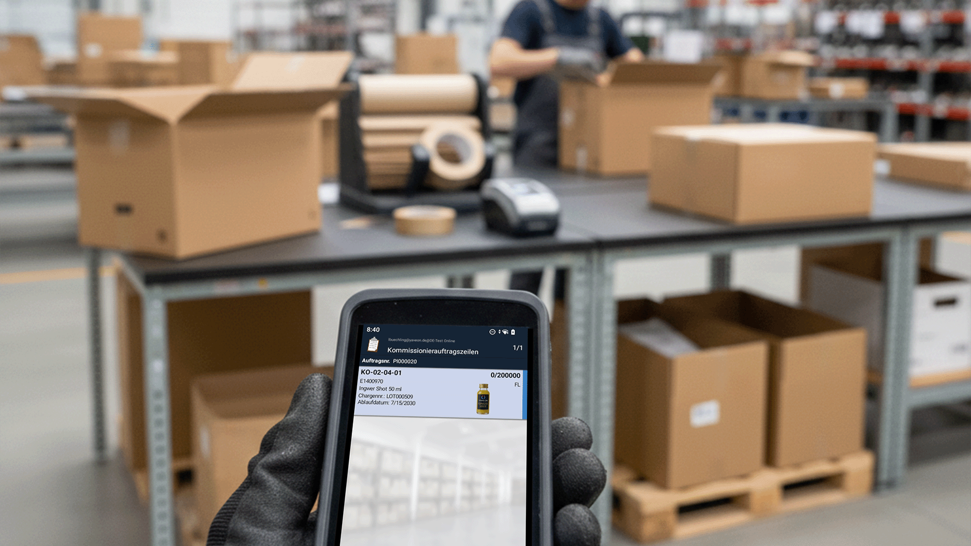 Person scanning a product with a smartphone in a warehouse.