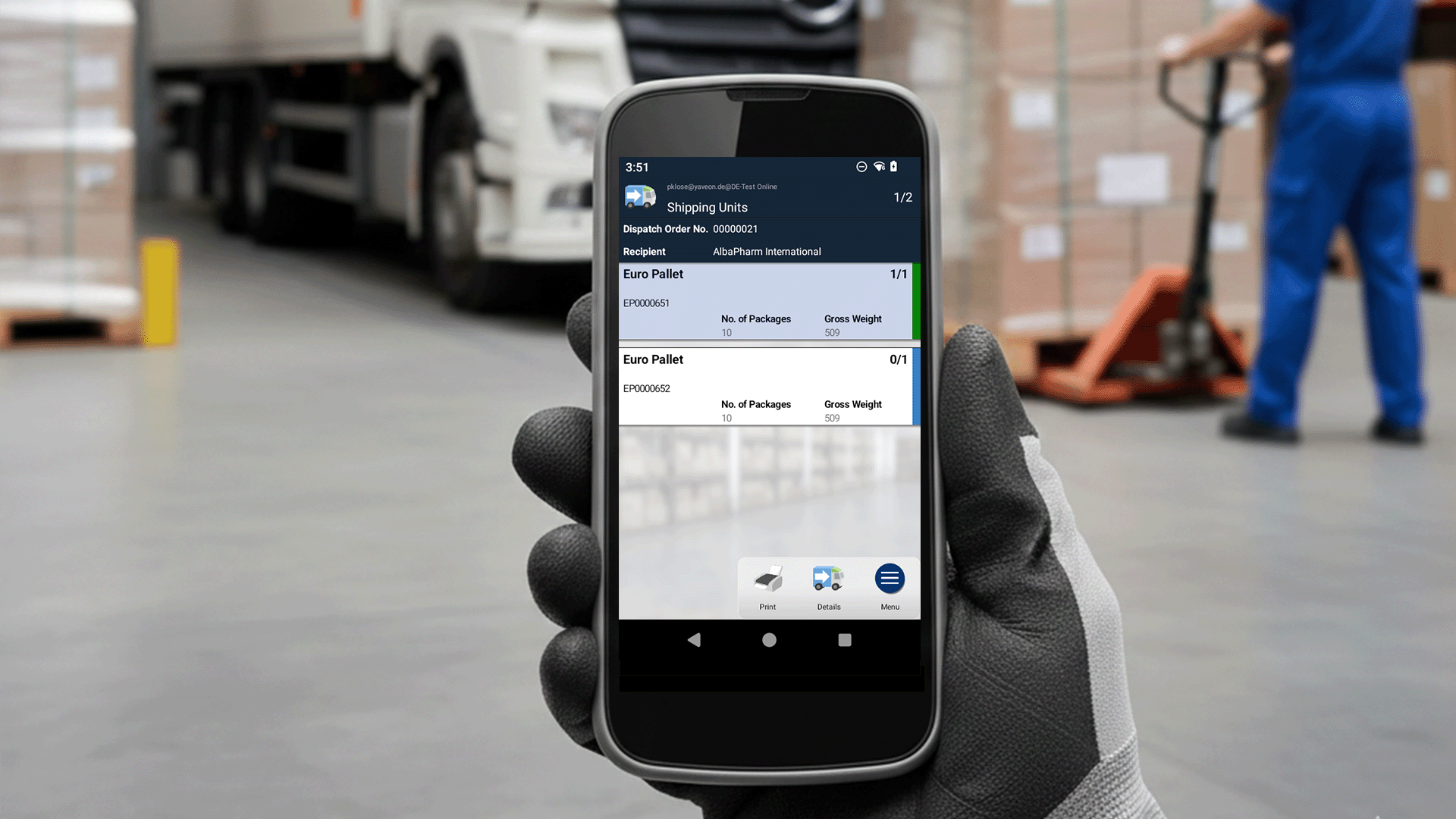 Logistics employee with smartphone app for pallet management.