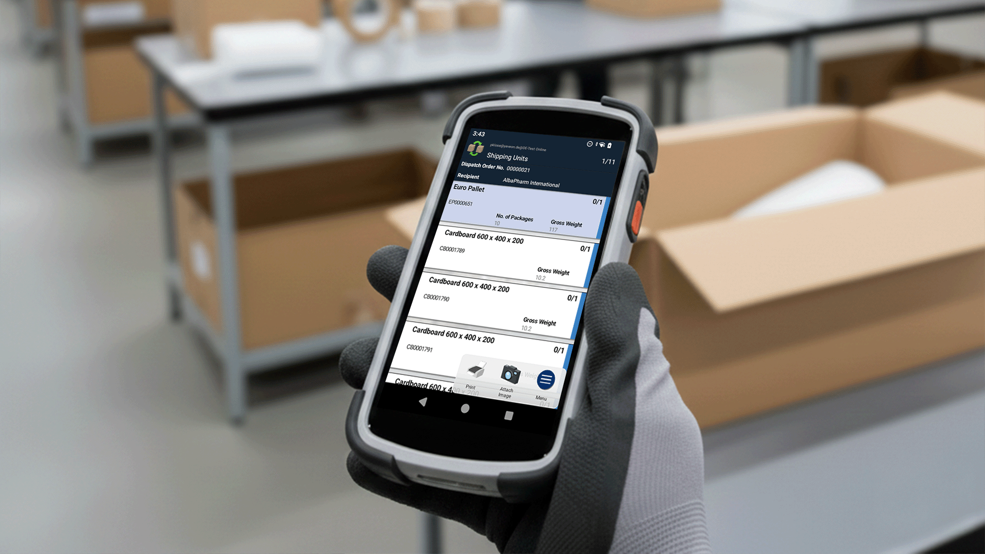 Warehouse worker scans packages with a mobile device in the warehouse.