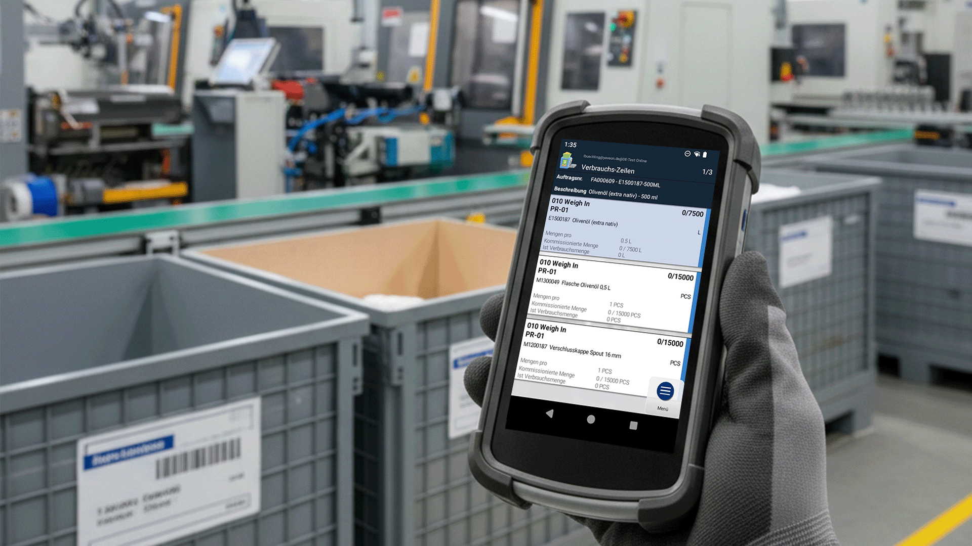 Worker scans inventory in factory with mobile device