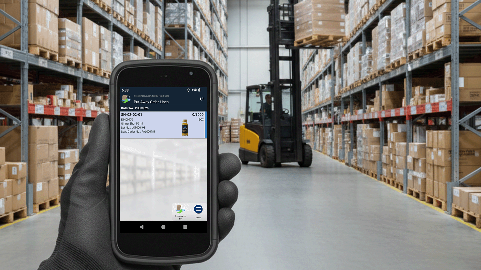 Warehouse worker with a handheld scanner and forklift in a warehouse.
