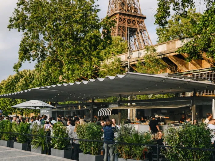 Outdoor terrace of a café in front of the Eiffel Tower in Paris.